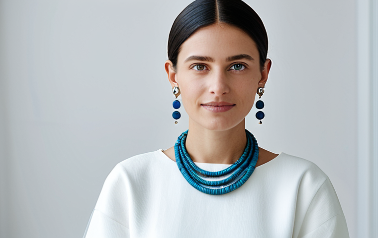 A stylish woman in a modern, modest outfit, showcasing elegant earrings crafted from recycled ocean plastics and a sleek necklace made from upcycled electronic components. She stands in a bright, minimalist studio with diffused natural light, emphasizing the innovative materials and contemporary design. The image captures perfect anatomy, correct proportions, and a natural pose, with well-formed hands and proper finger count. This professional photography piece highlights sustainable fashion, appropriate content, safe for work, fully clothed, and family-friendly.